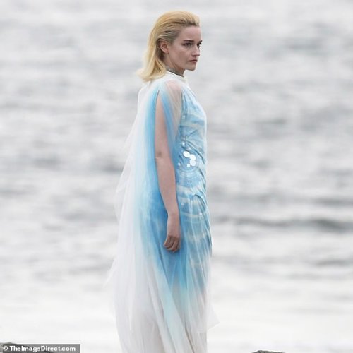 98147013-14689067-She_wore_a_white_and_blue_patterned_dress_that_had_caped_details-a-144_1746654956485.jpg